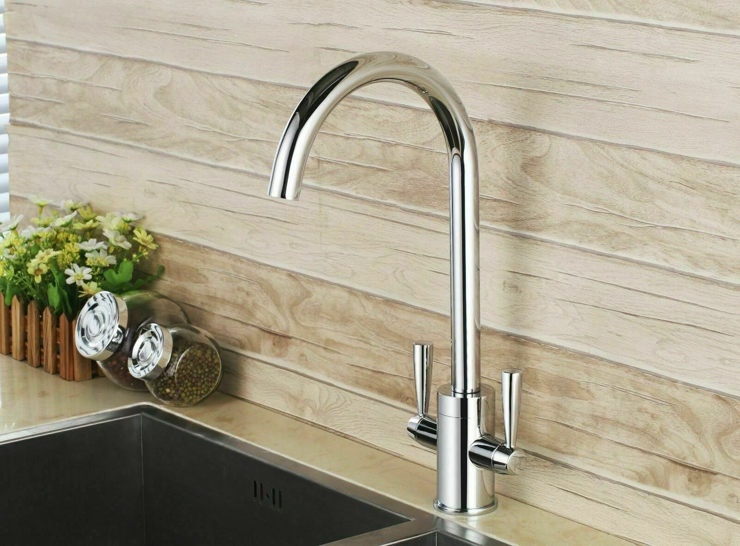 Modern chrome kitchen mixer tap with twin levers